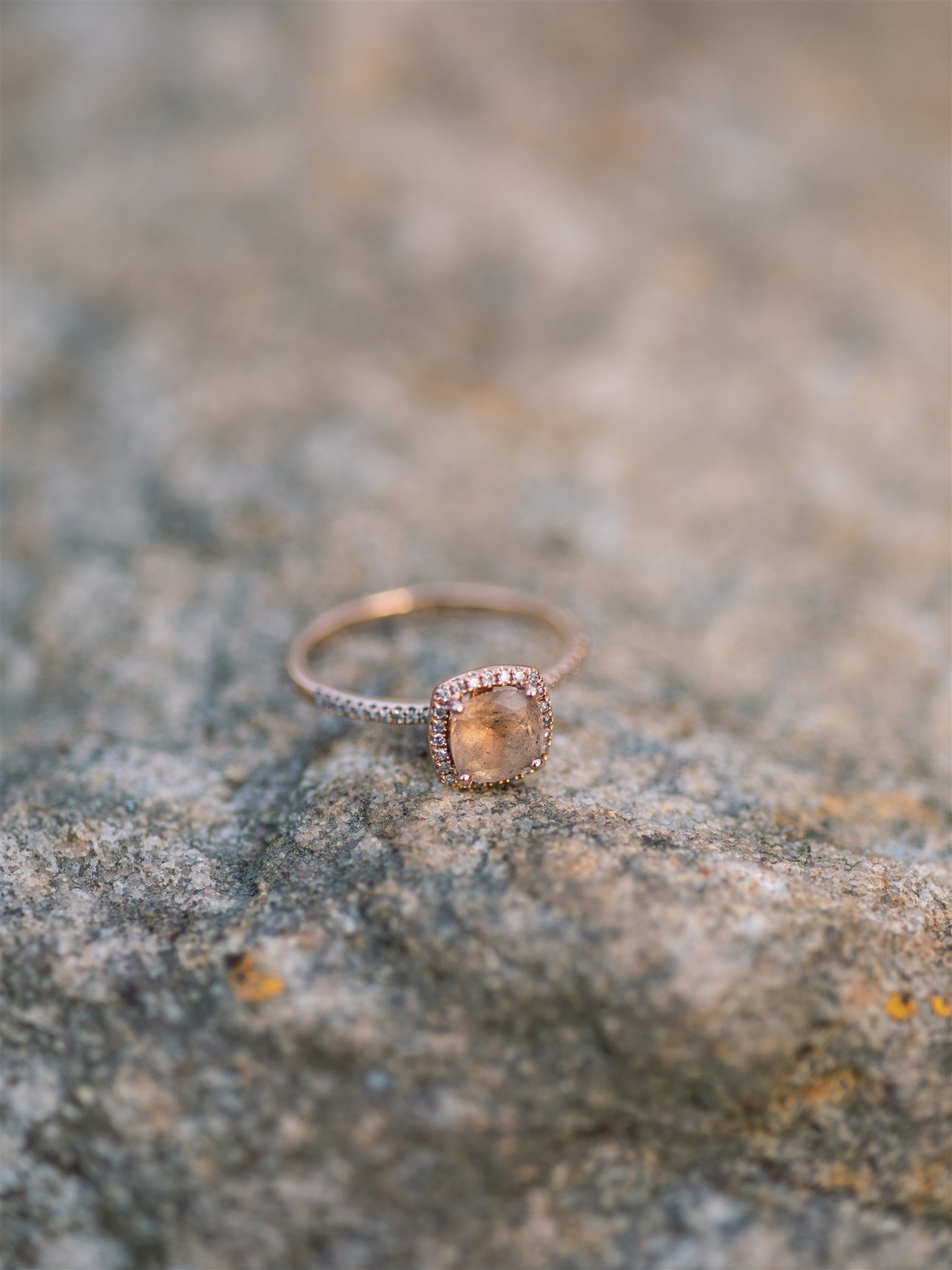 custom engagement ring sits on rock during winter engagement session