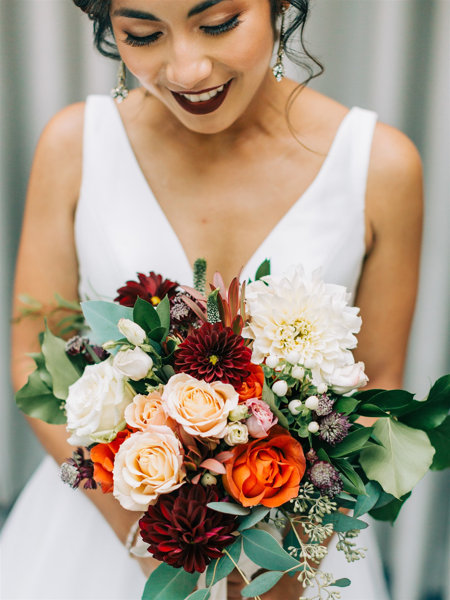 bride holds fall bouquet for Winery at Bull Run wedding