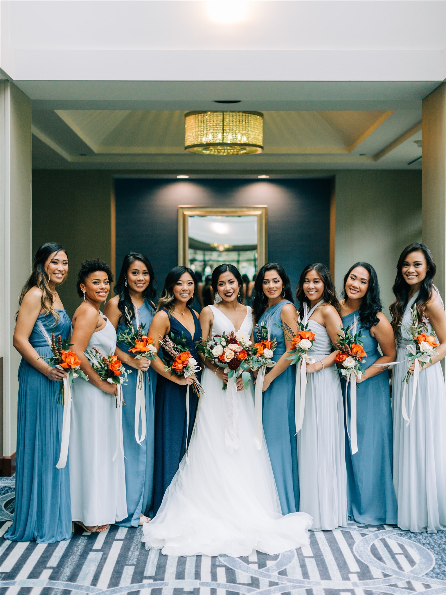 bridesmaids in blue gowns pose before Winery at Bull Run wedding