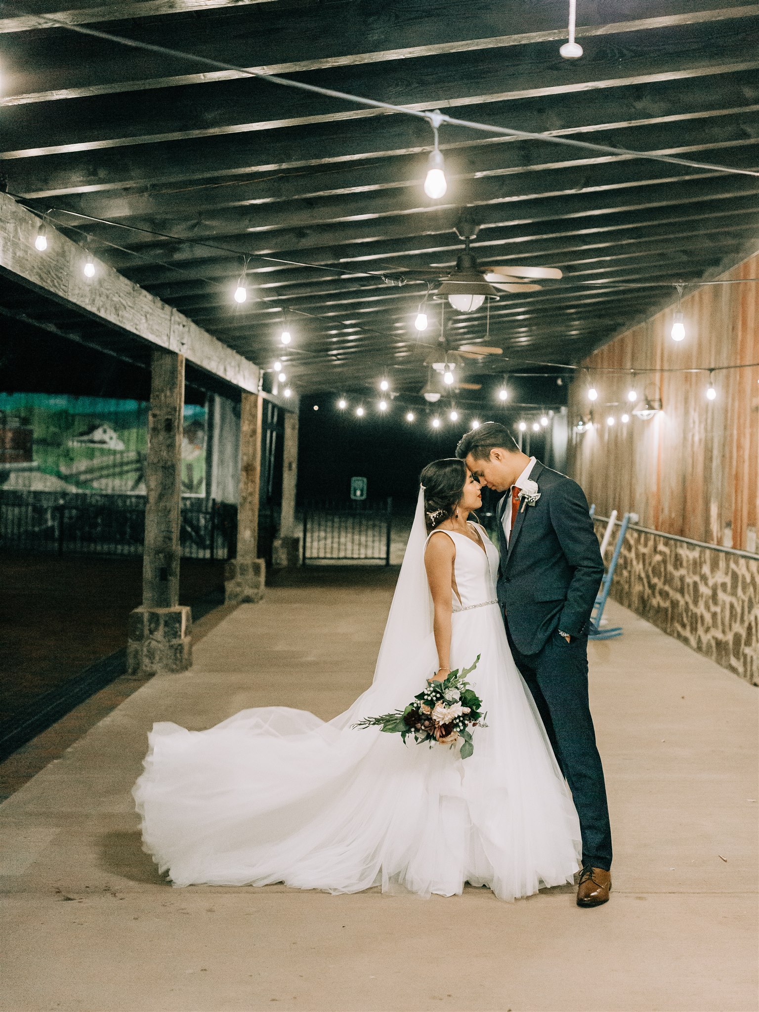 bride and groom pose under overhang at Winery at Bull Run