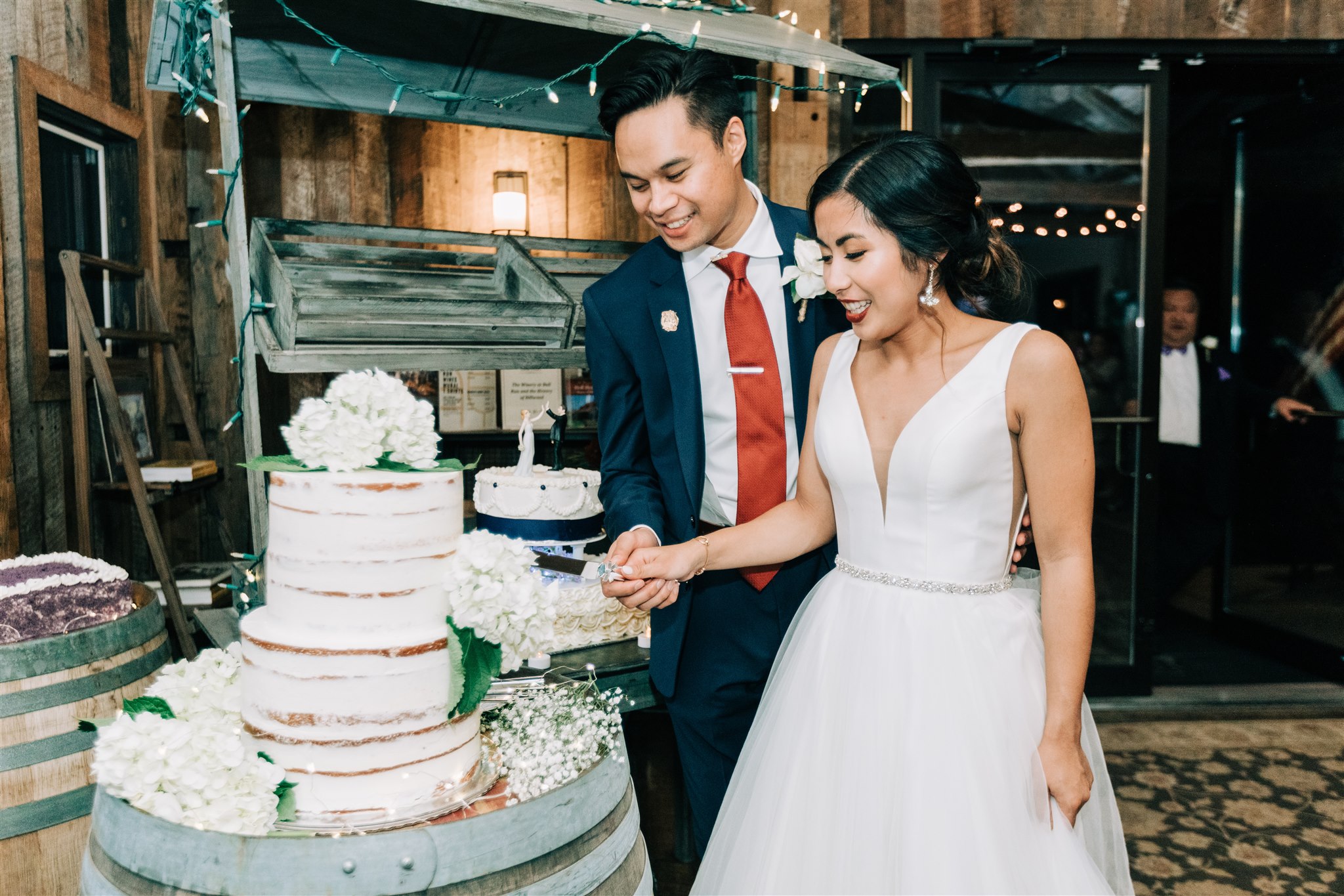 bride and groom cut wedding cake at Winery at Bull Run