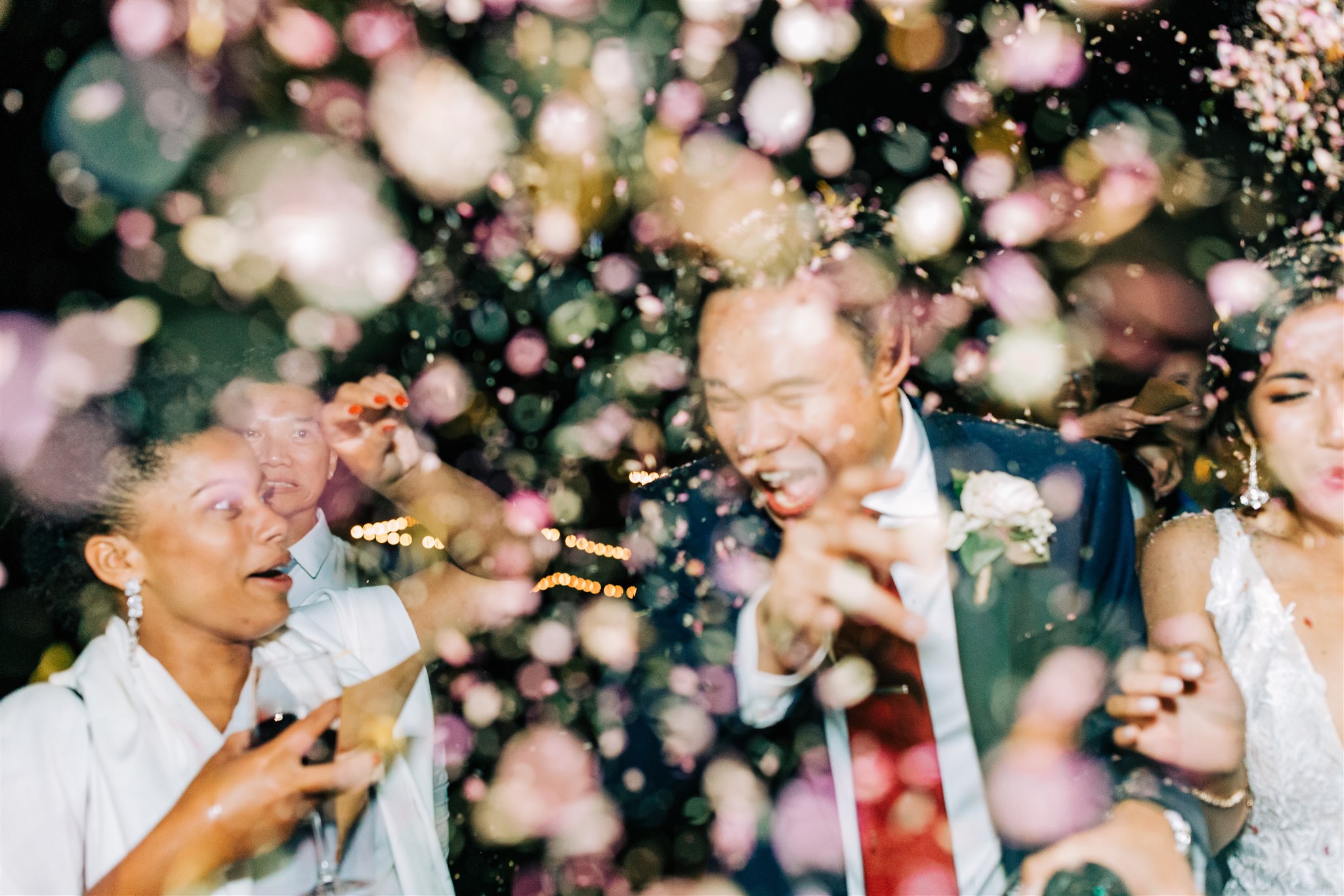newlyweds cheer during confetti toss sendoff
