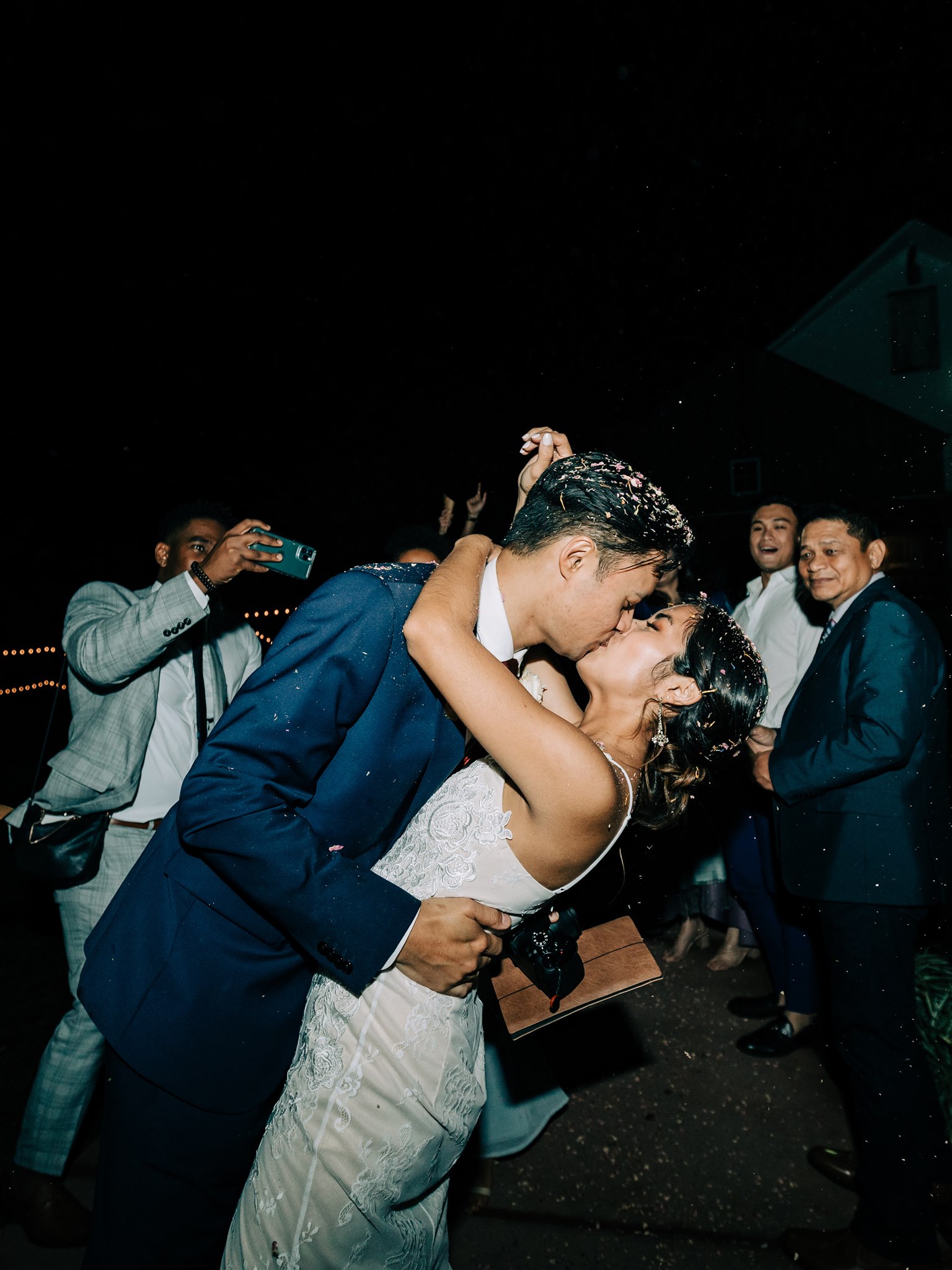 newlyweds kiss during confetti toss sendoff