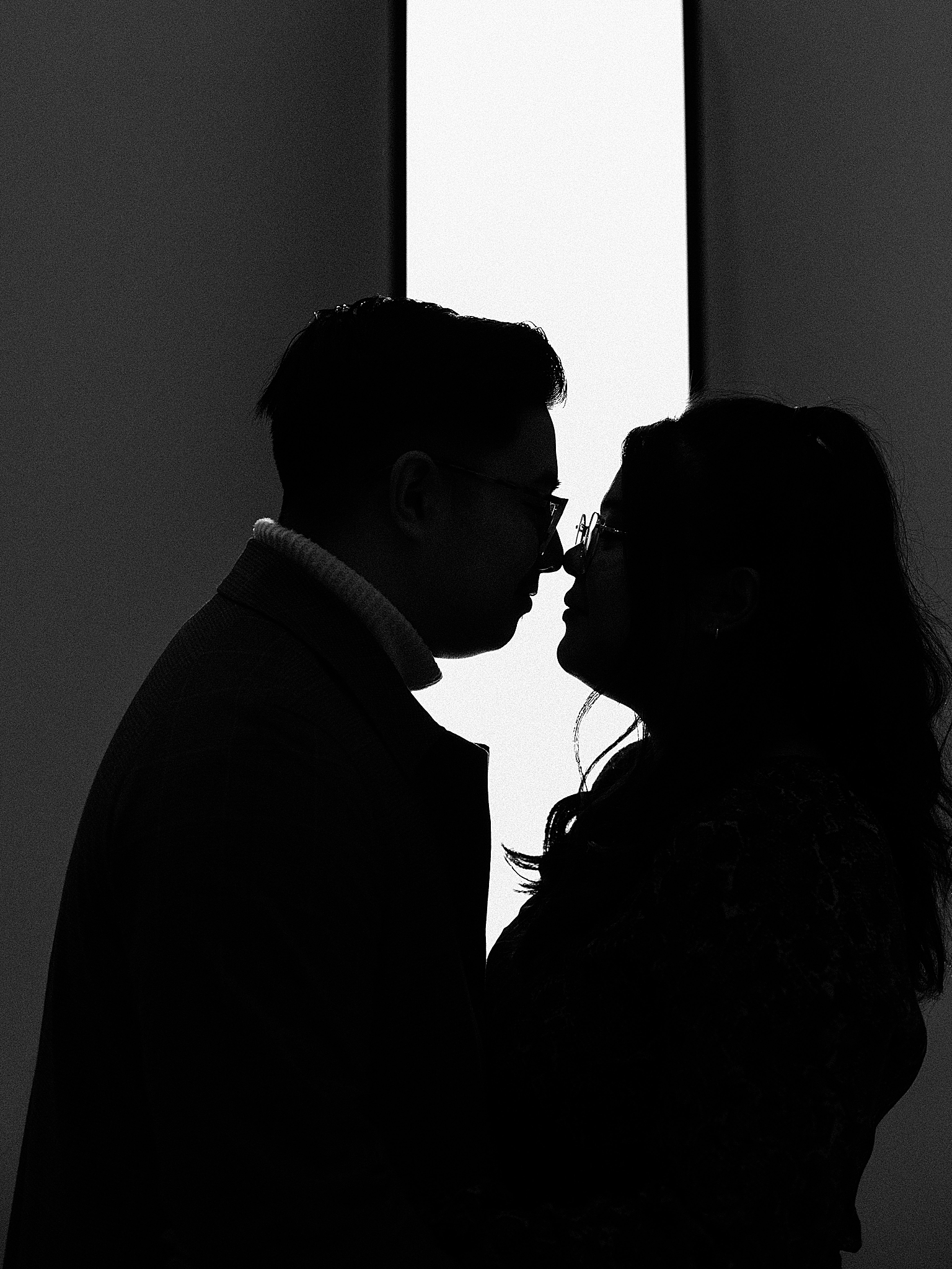 silhouette of couple touching noses by artwork