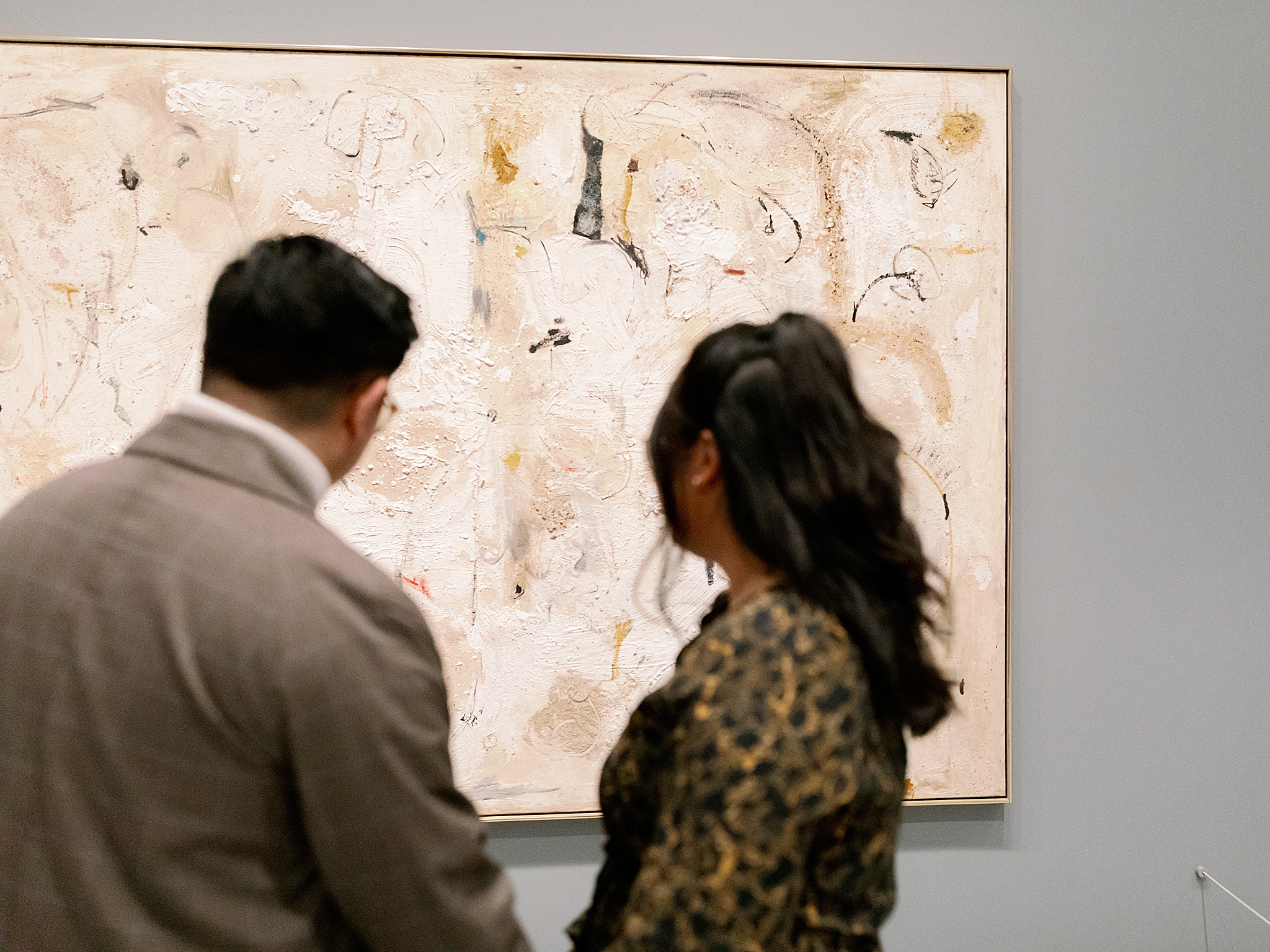 couple admires art during Art Museum Engagement Session