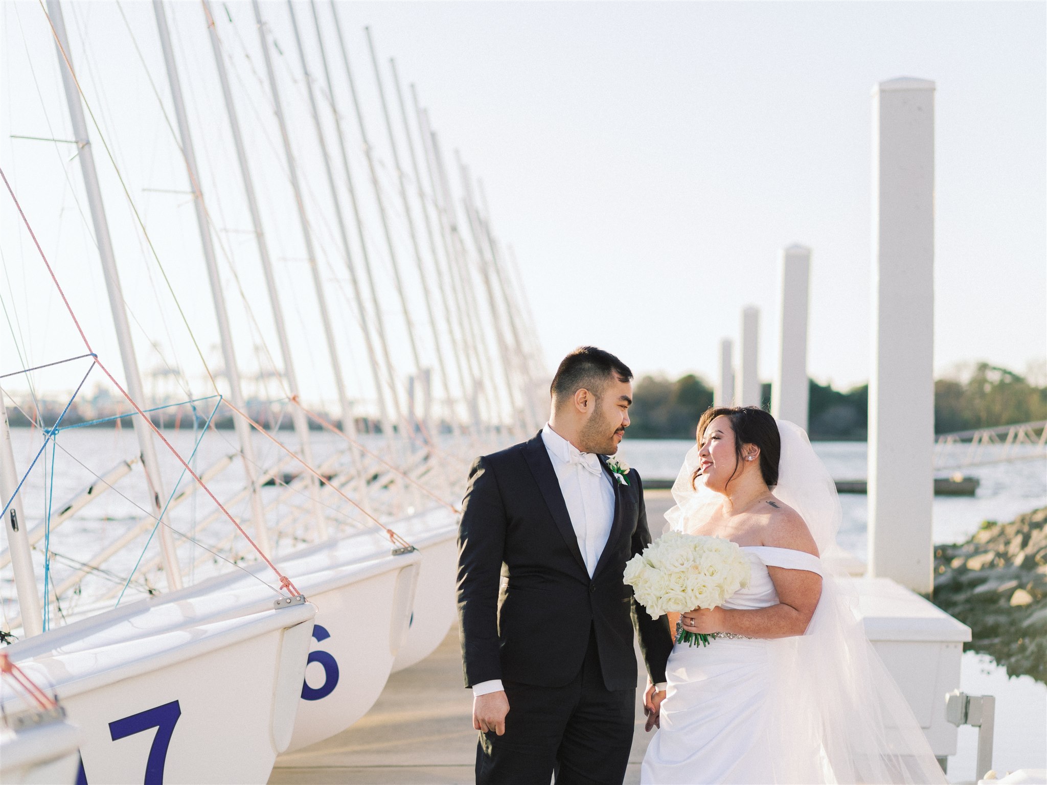 newlyweds walk on marina in Norfolk VA