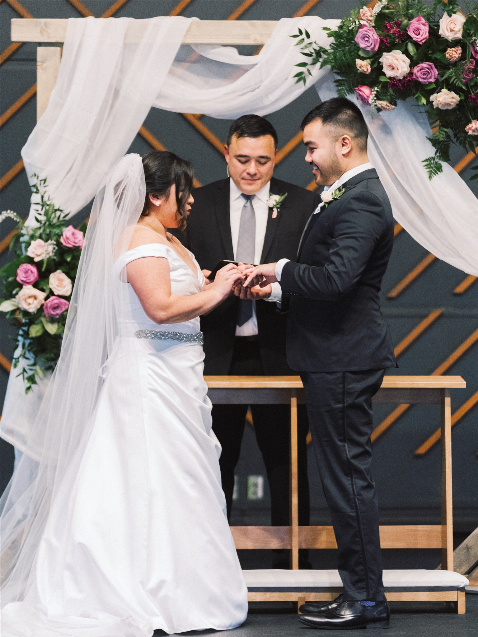 bride and groom exchange rings during VA wedding ceremony