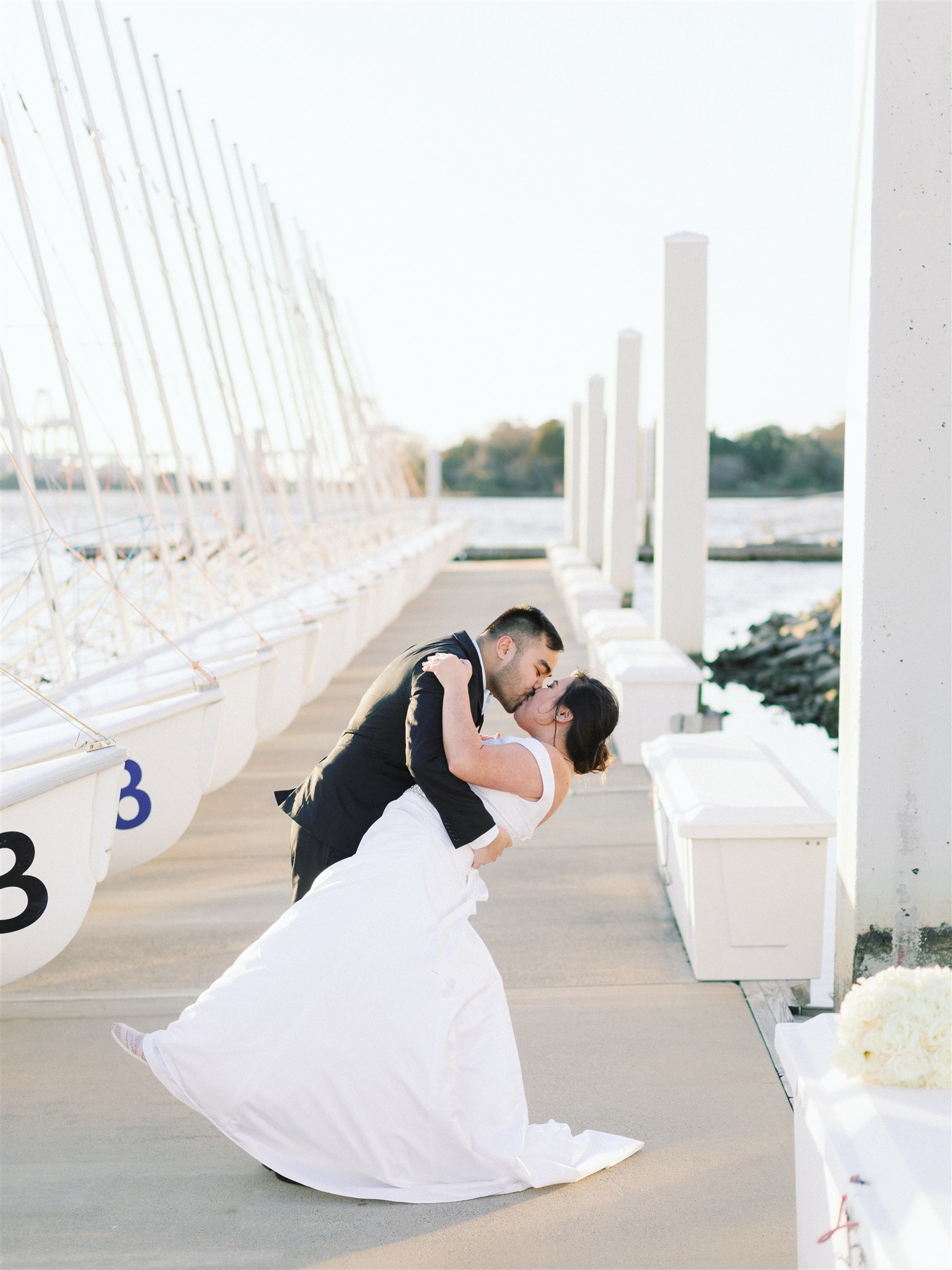 groom dips bride during Norfolk VA wedding portraits