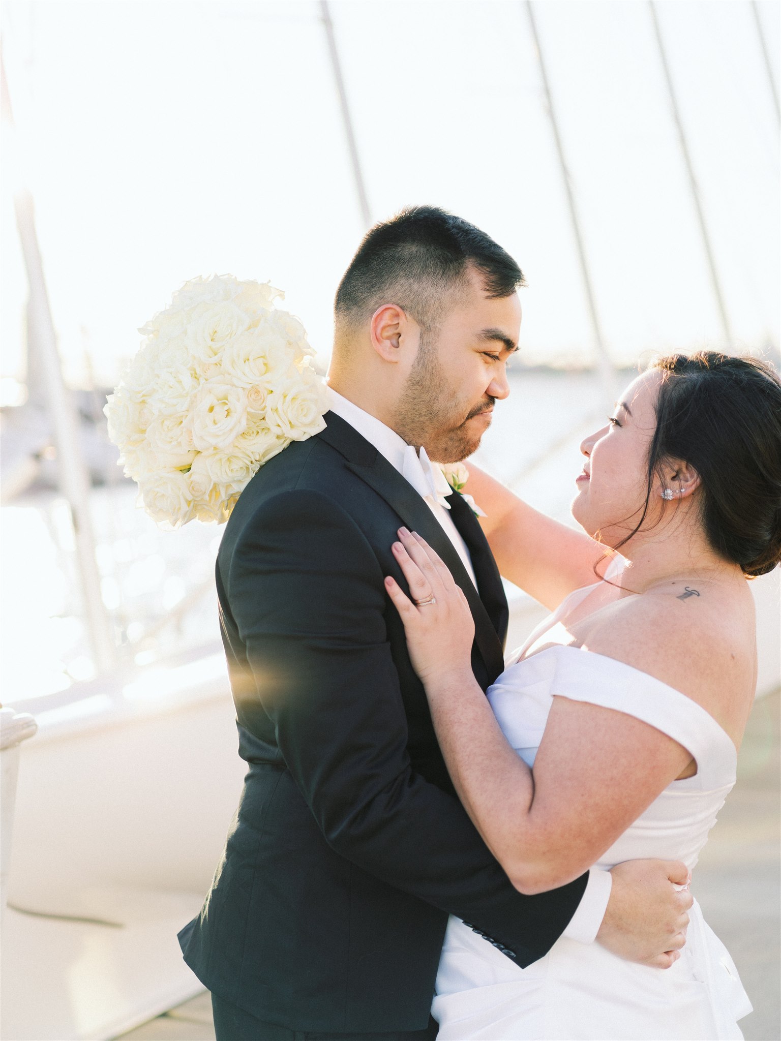 newlyweds stand together by boats in Norfolk VA