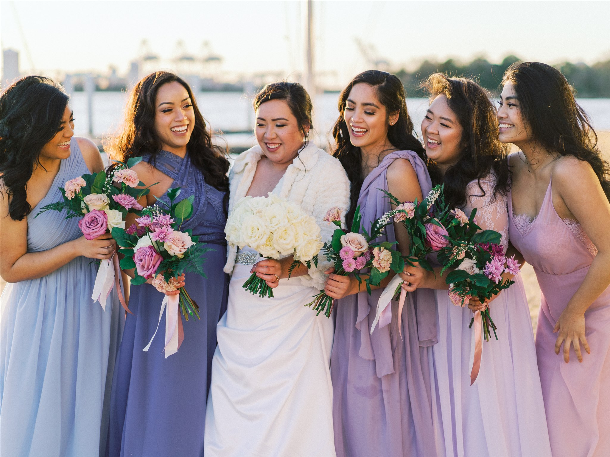 beach portraits of wedding party in mismatched gowns