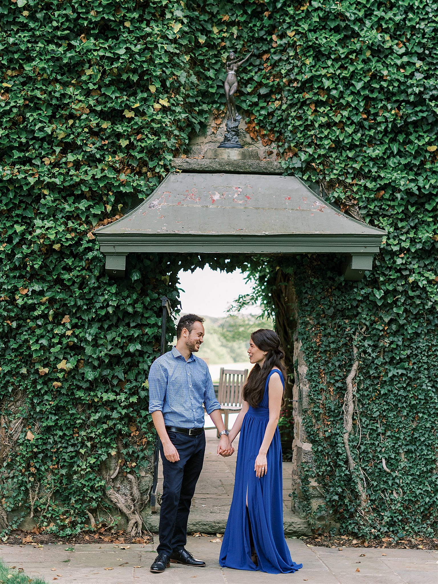 couple poses by ivy wall at Goodstone Inn