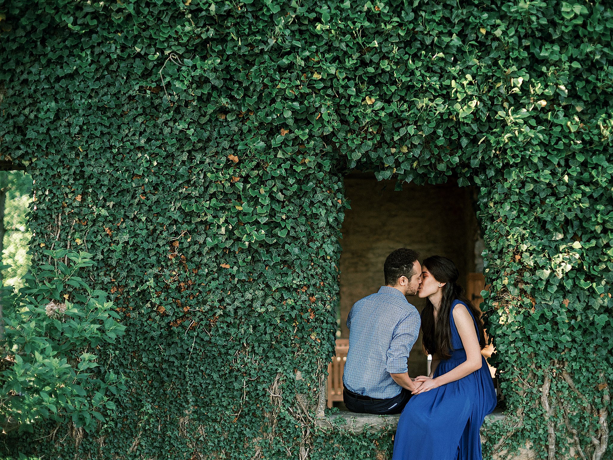 Goodstone Inn engagement session for couple sitting in ivy covered window