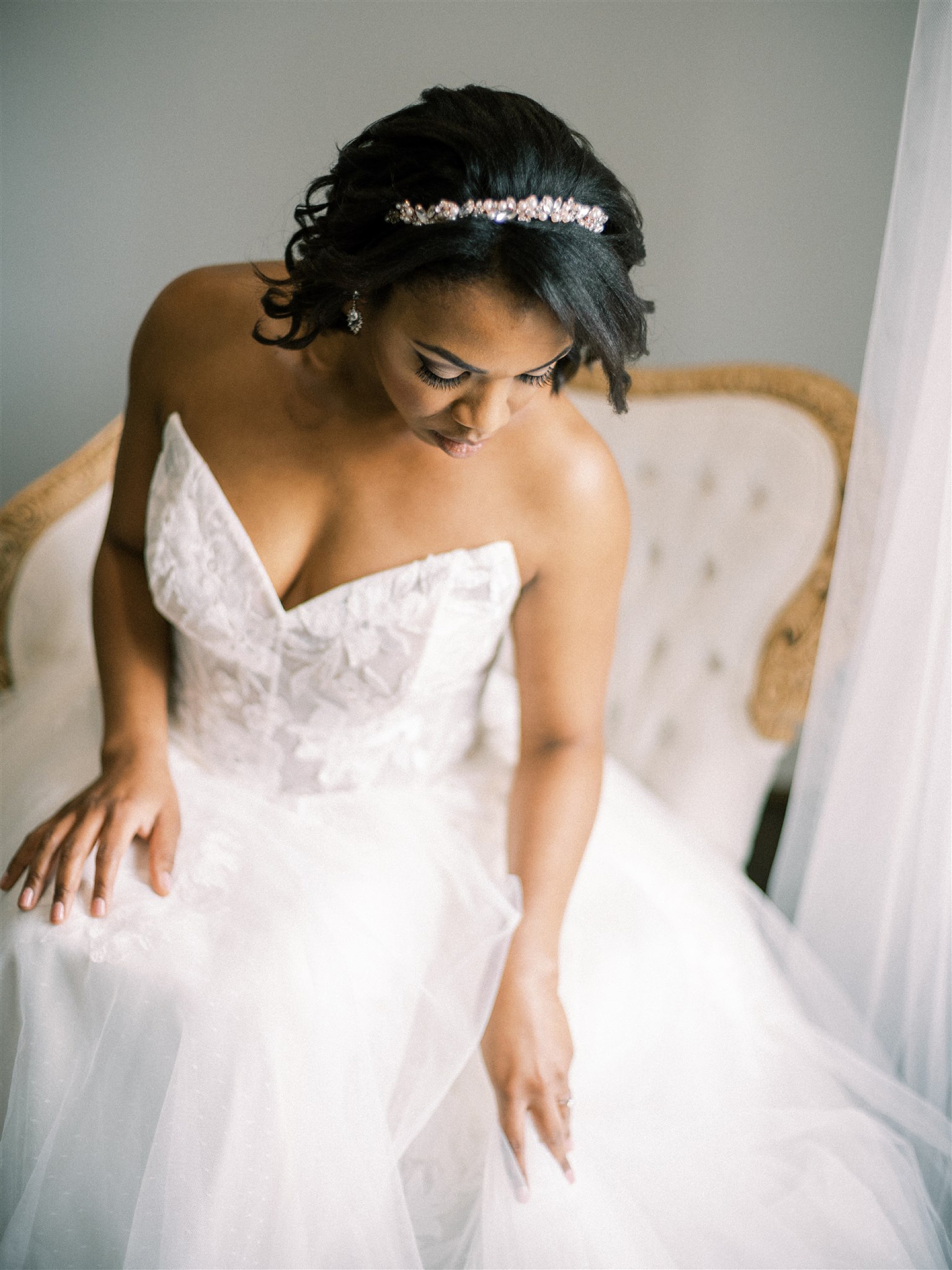 bride looks down at wedding gown before VA microwedding