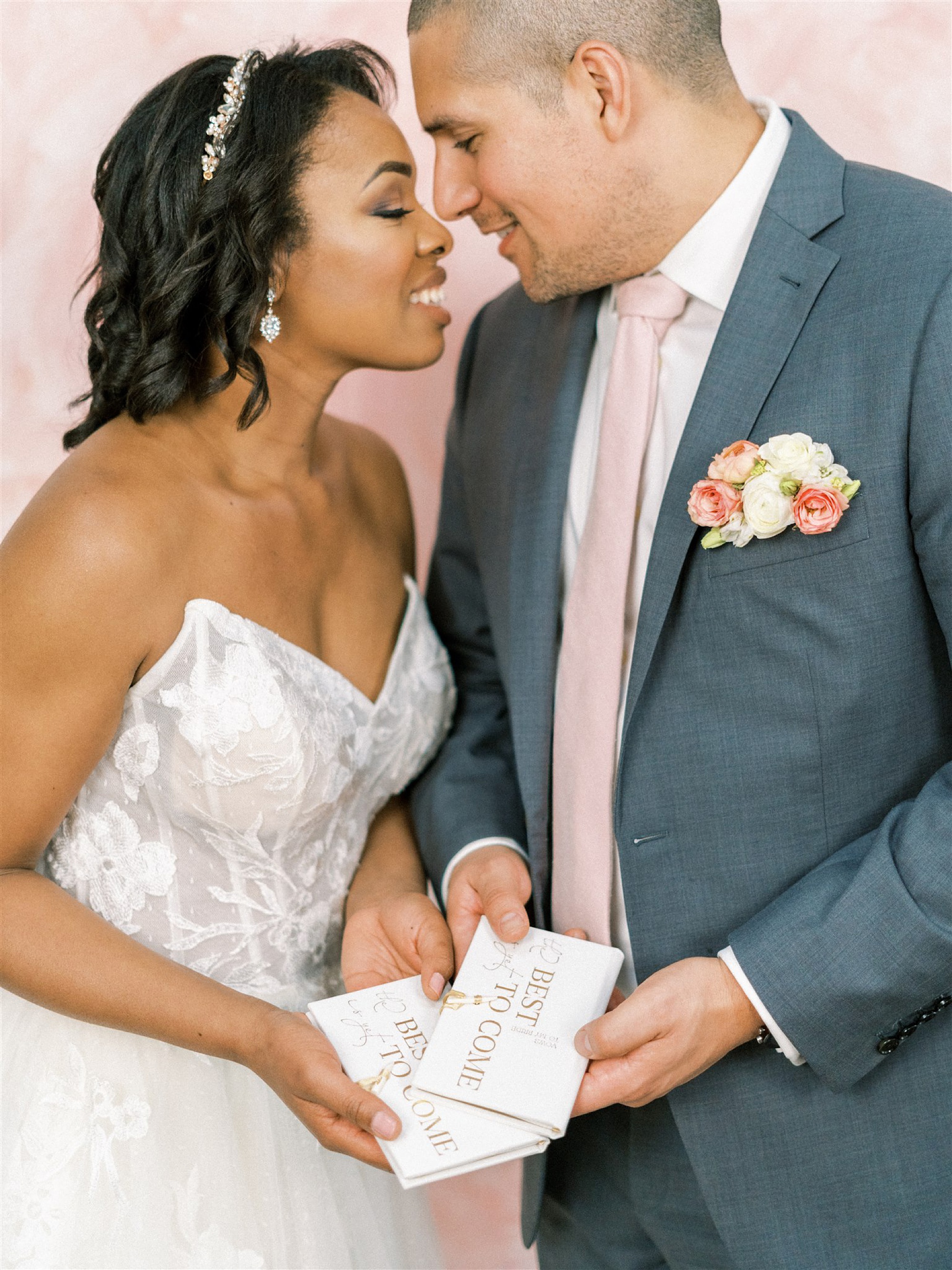 bride and groom hold vow booklets before microwedding