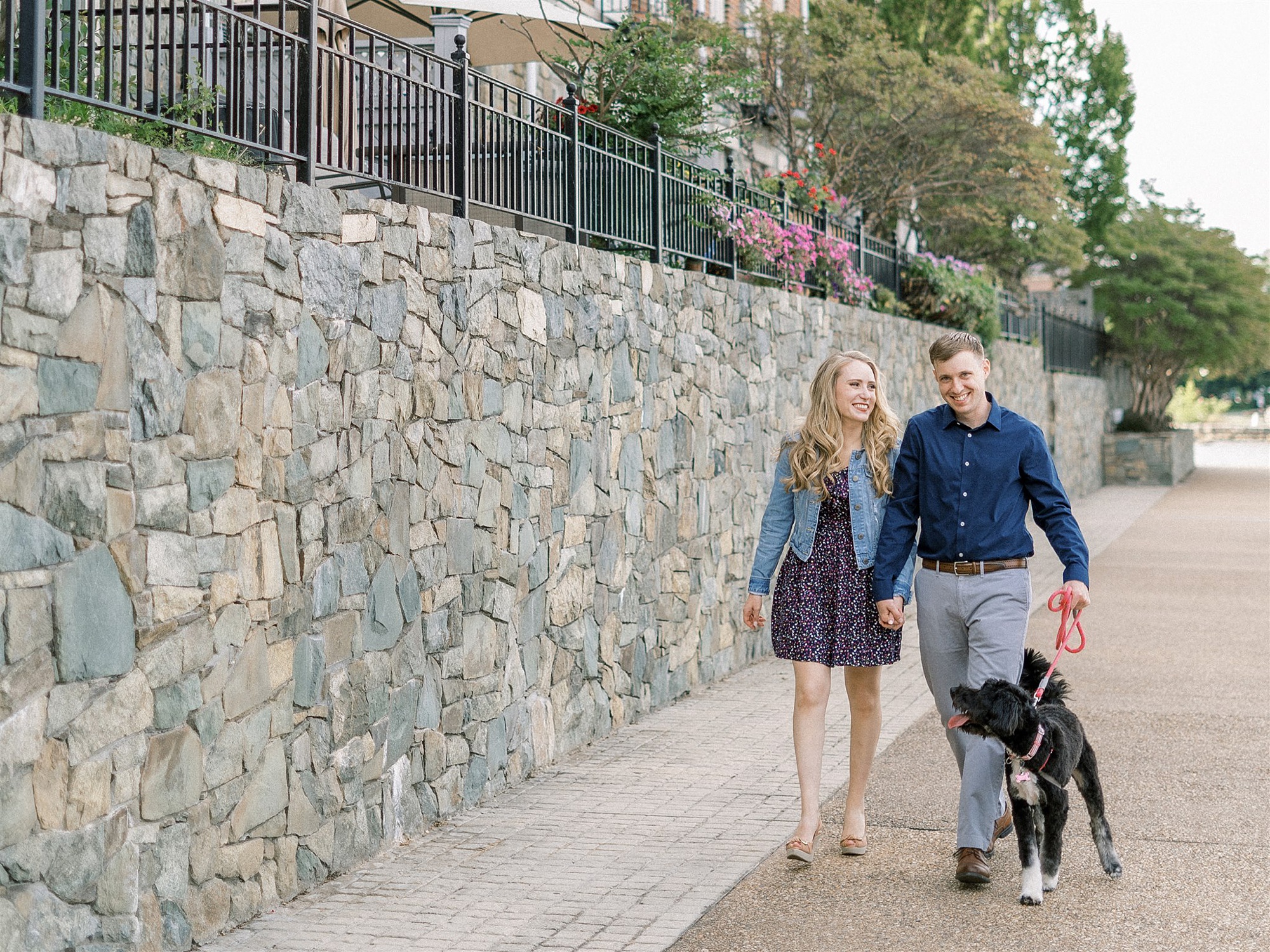 couple walks dog along waterfront in Old Town Alexandria