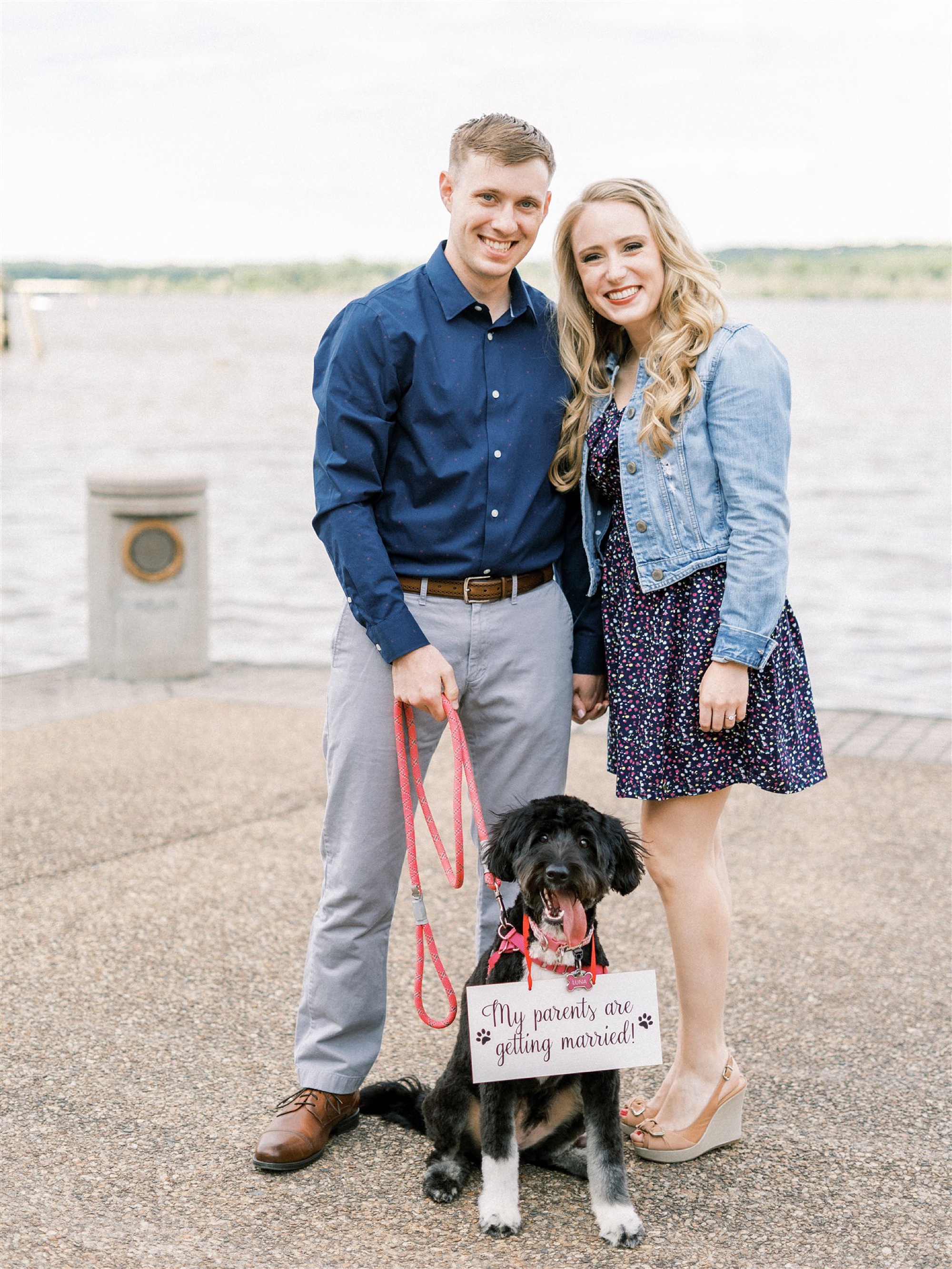 engaged couple poses in front of Potomac River during Old Town Alexandria engagement session