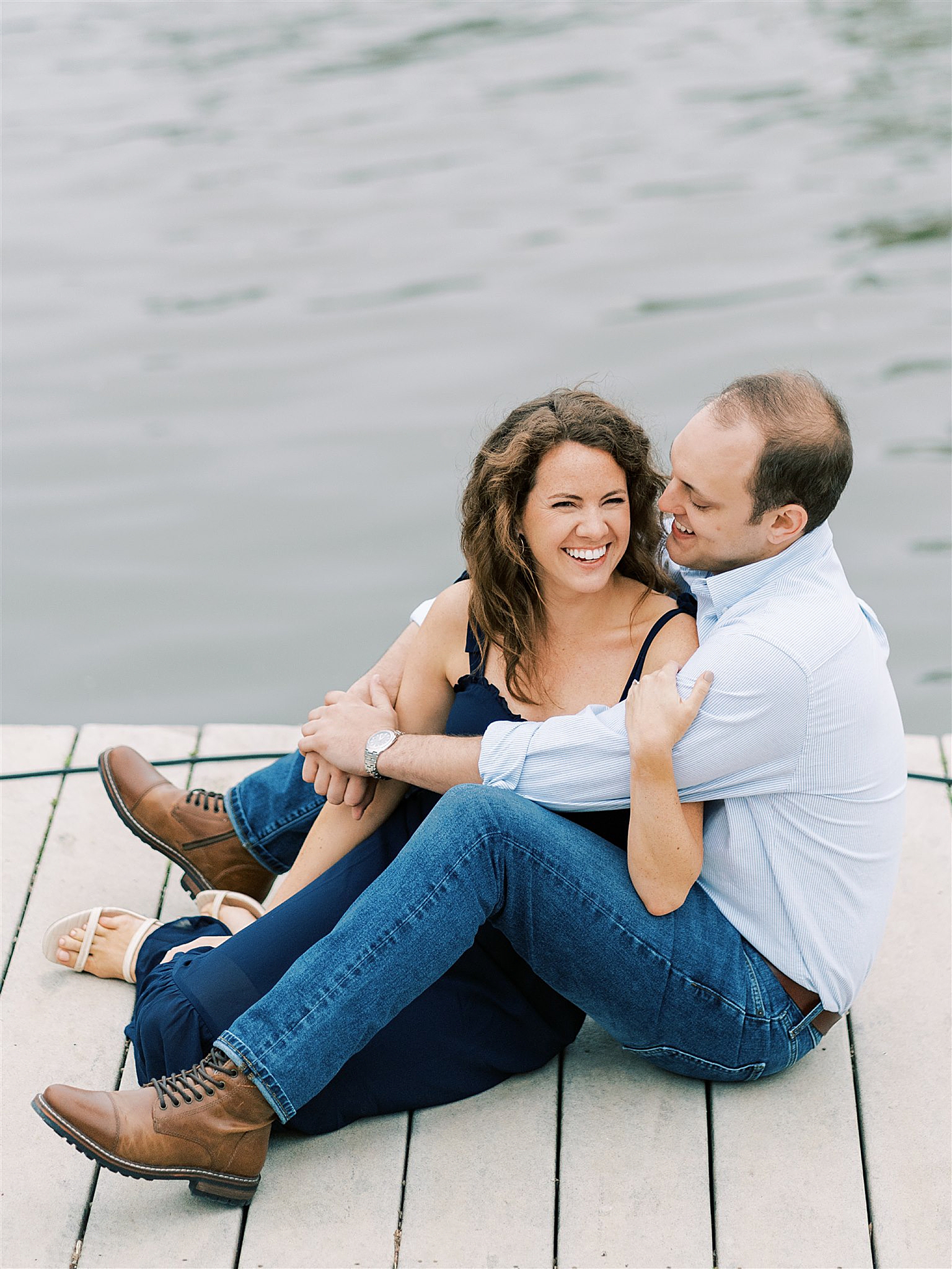 bride and groom sit on dock in Old Town Alexandria