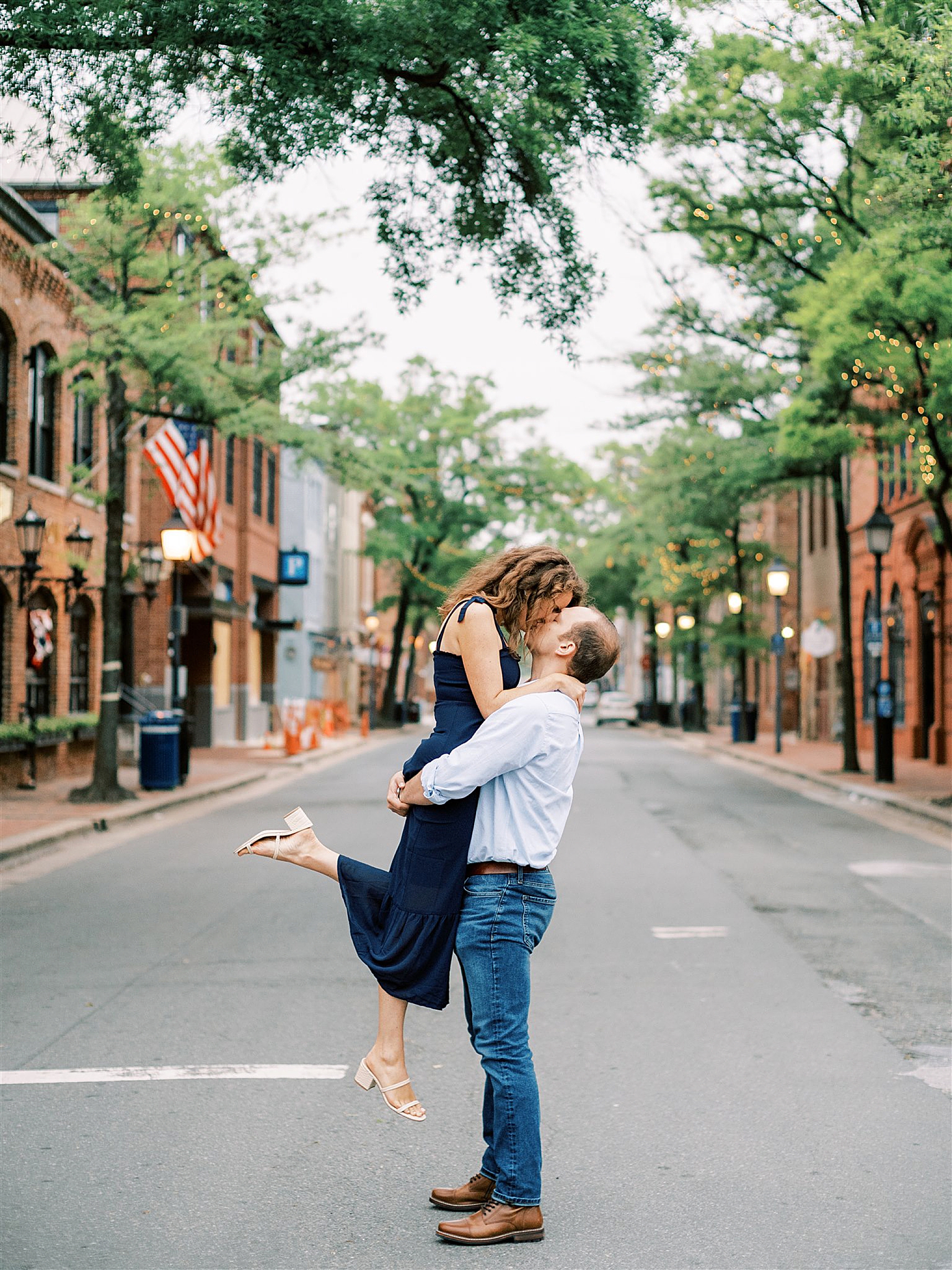 groom lifts bride during engagement photos in Old Town Alexandria