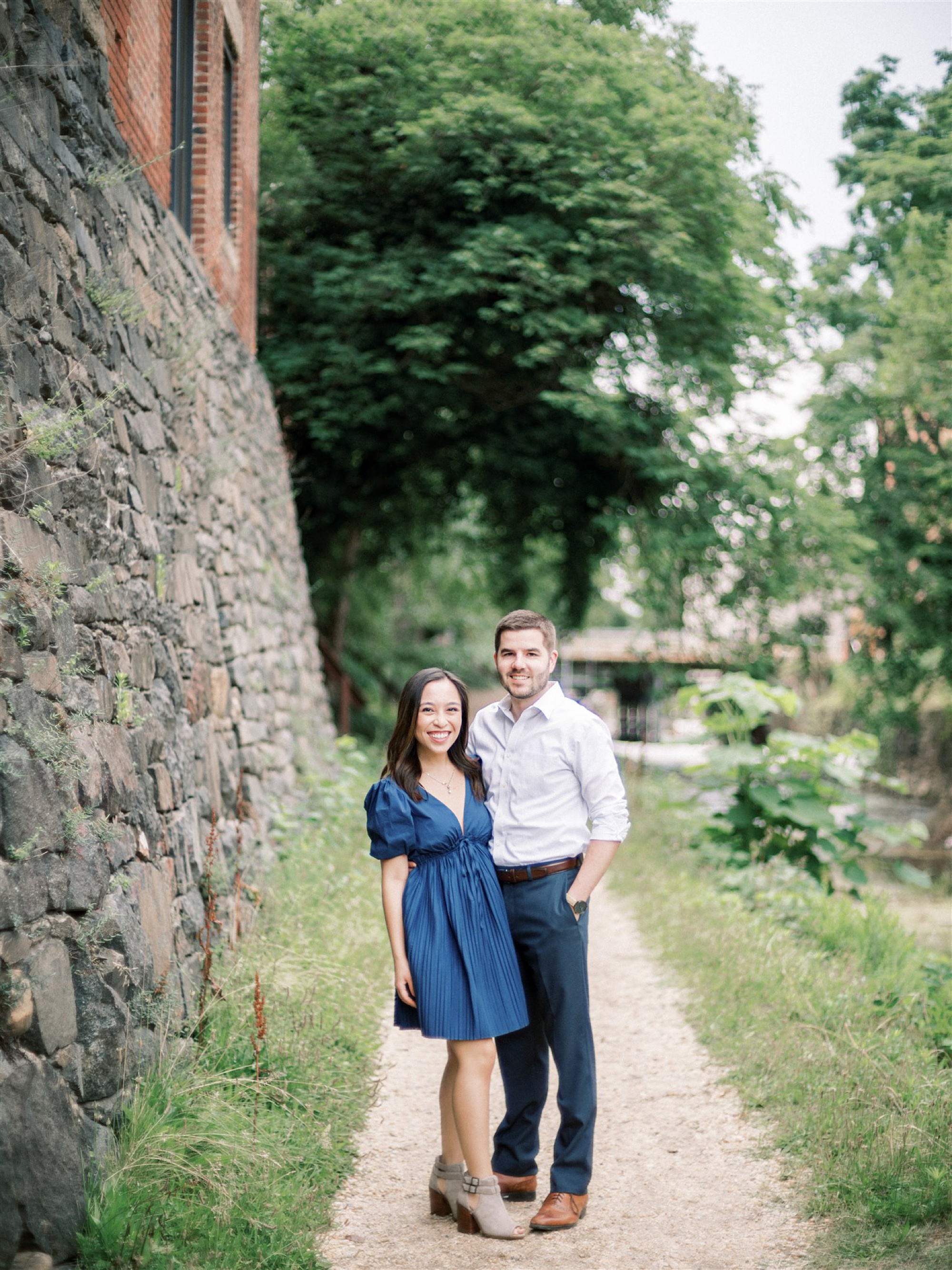 engaged couple poses by canal in Georgetown 
