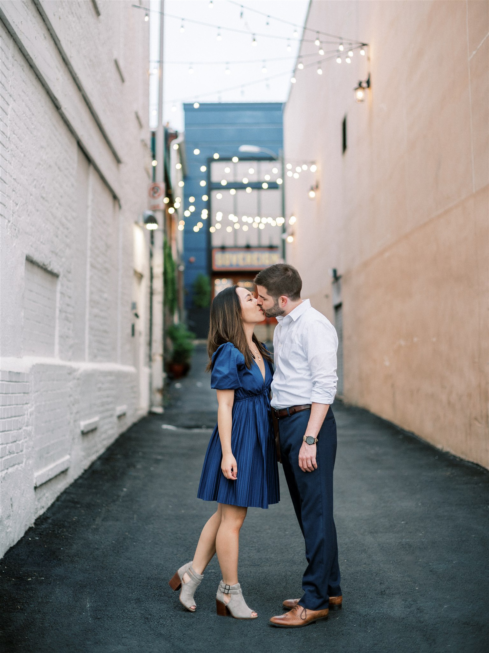 engaged couple kisses in alleyway of Georgetown