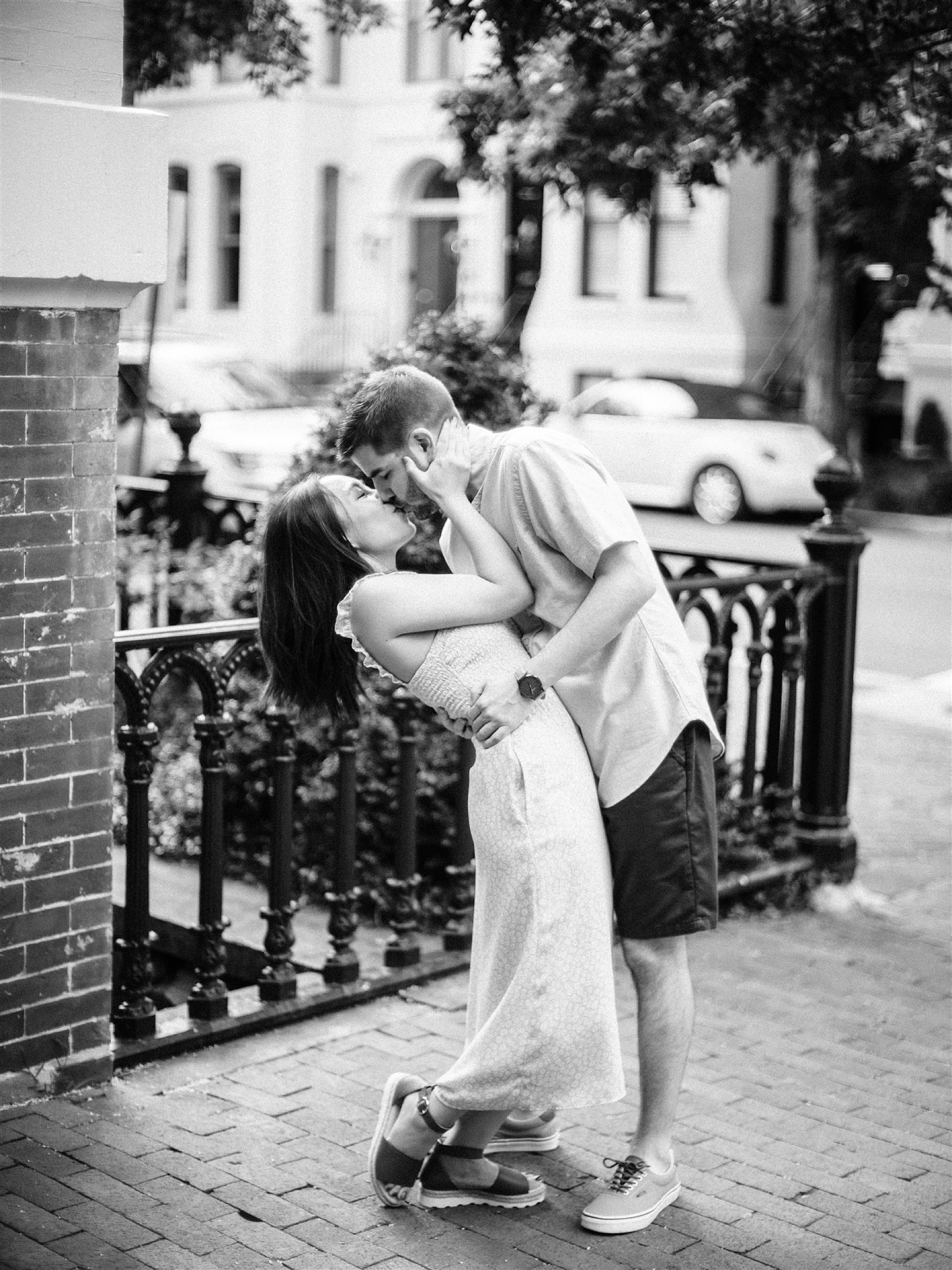 bride and groom kiss on sidewalk during Georgetown DC Engagement Session