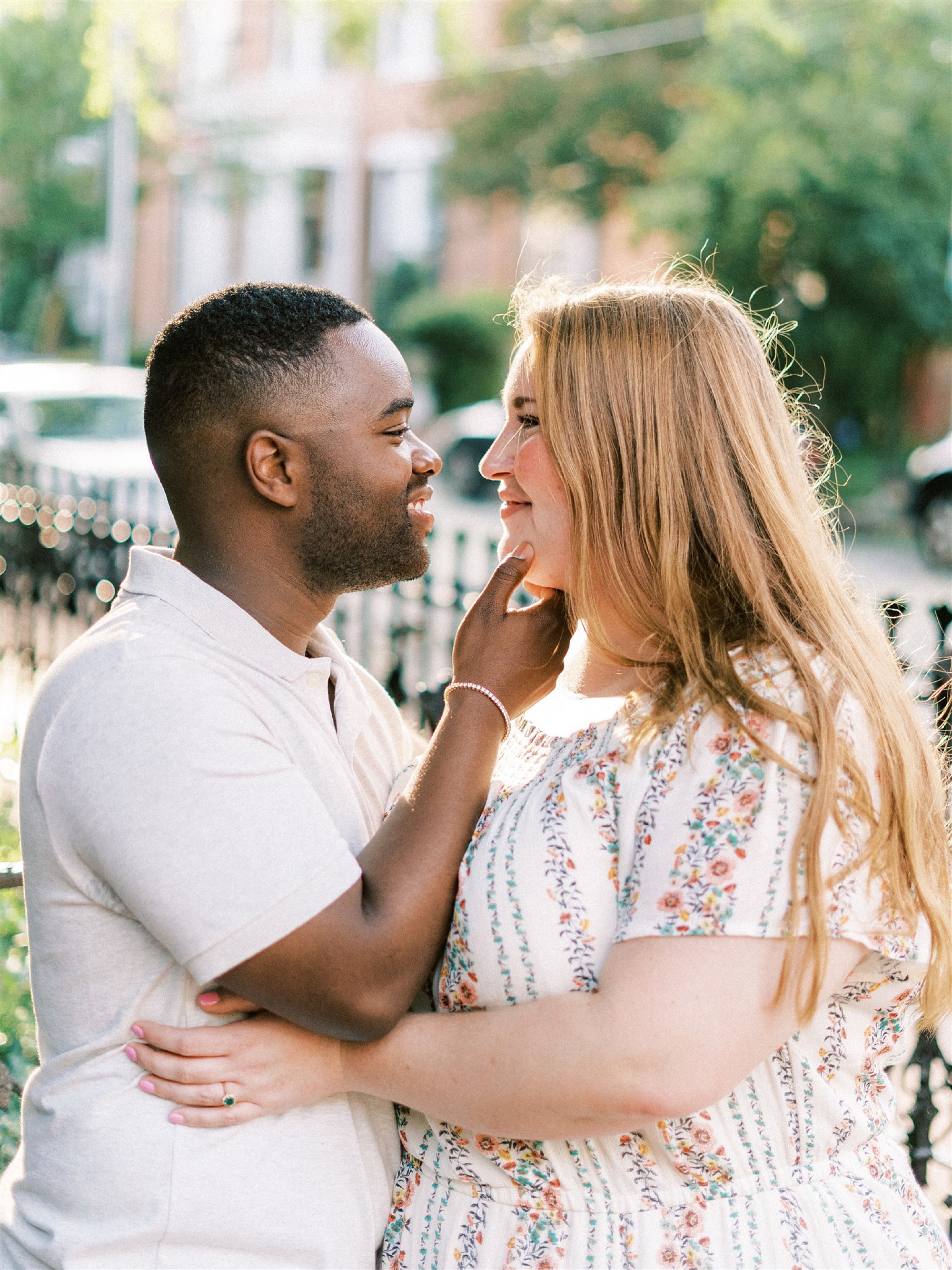 engaged couple poses on street in Freemason District