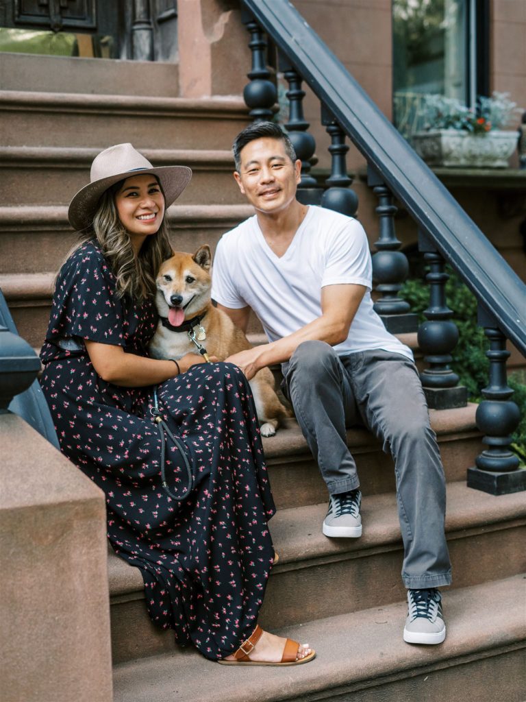 dog sitters sit with dog on steps of Brooklyn brownstone