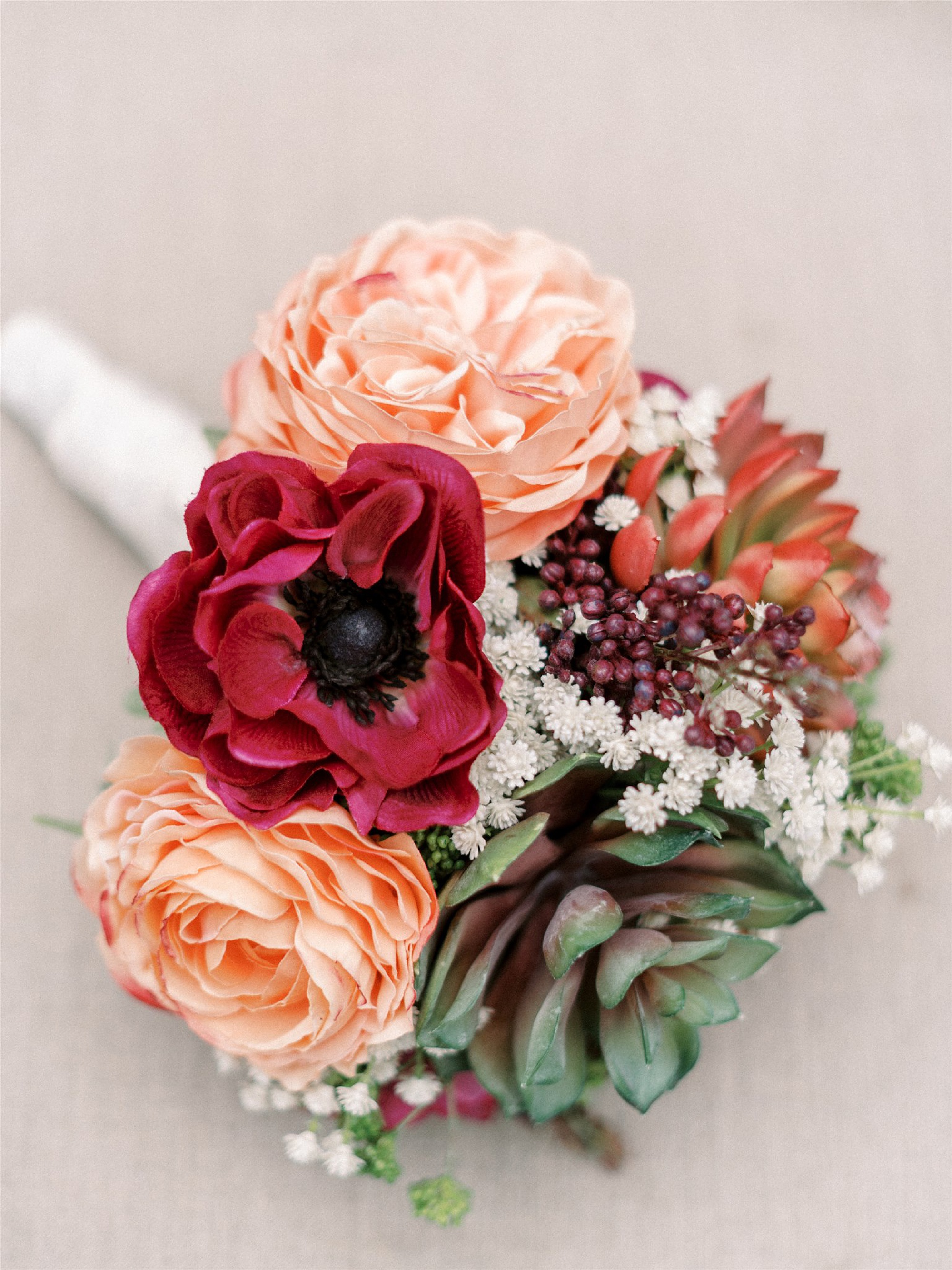 bride's bouquet with peach and red flowers