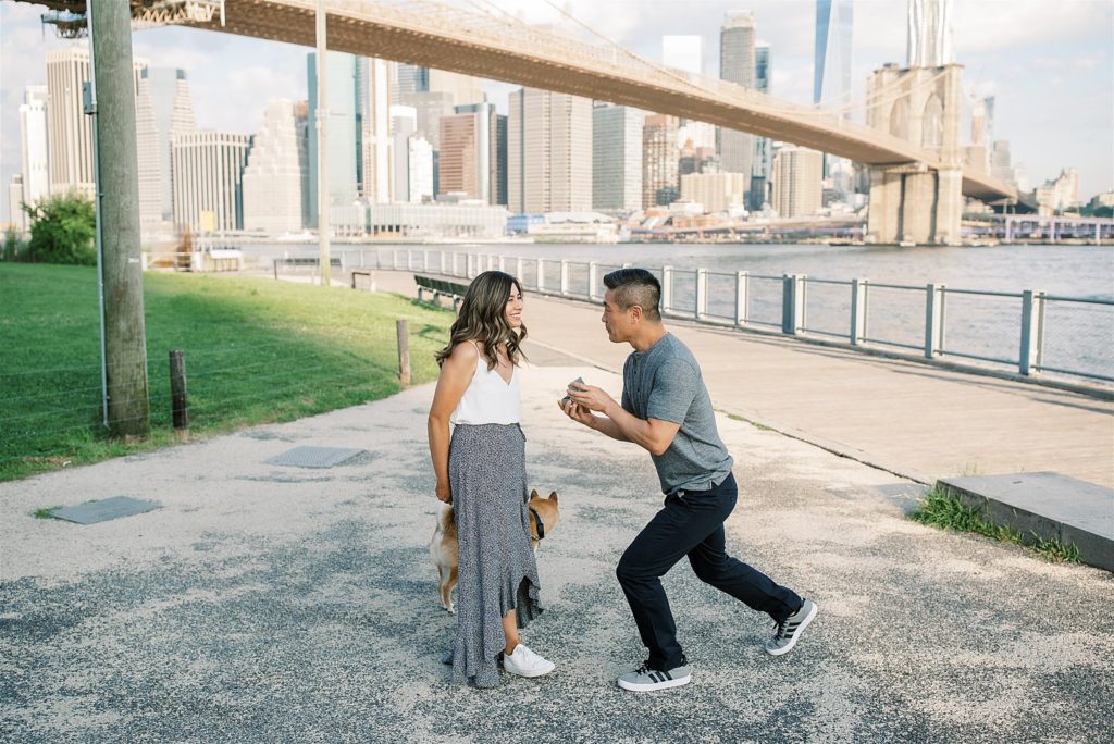 groom hands ring to fiancee during surprise NYC proposal