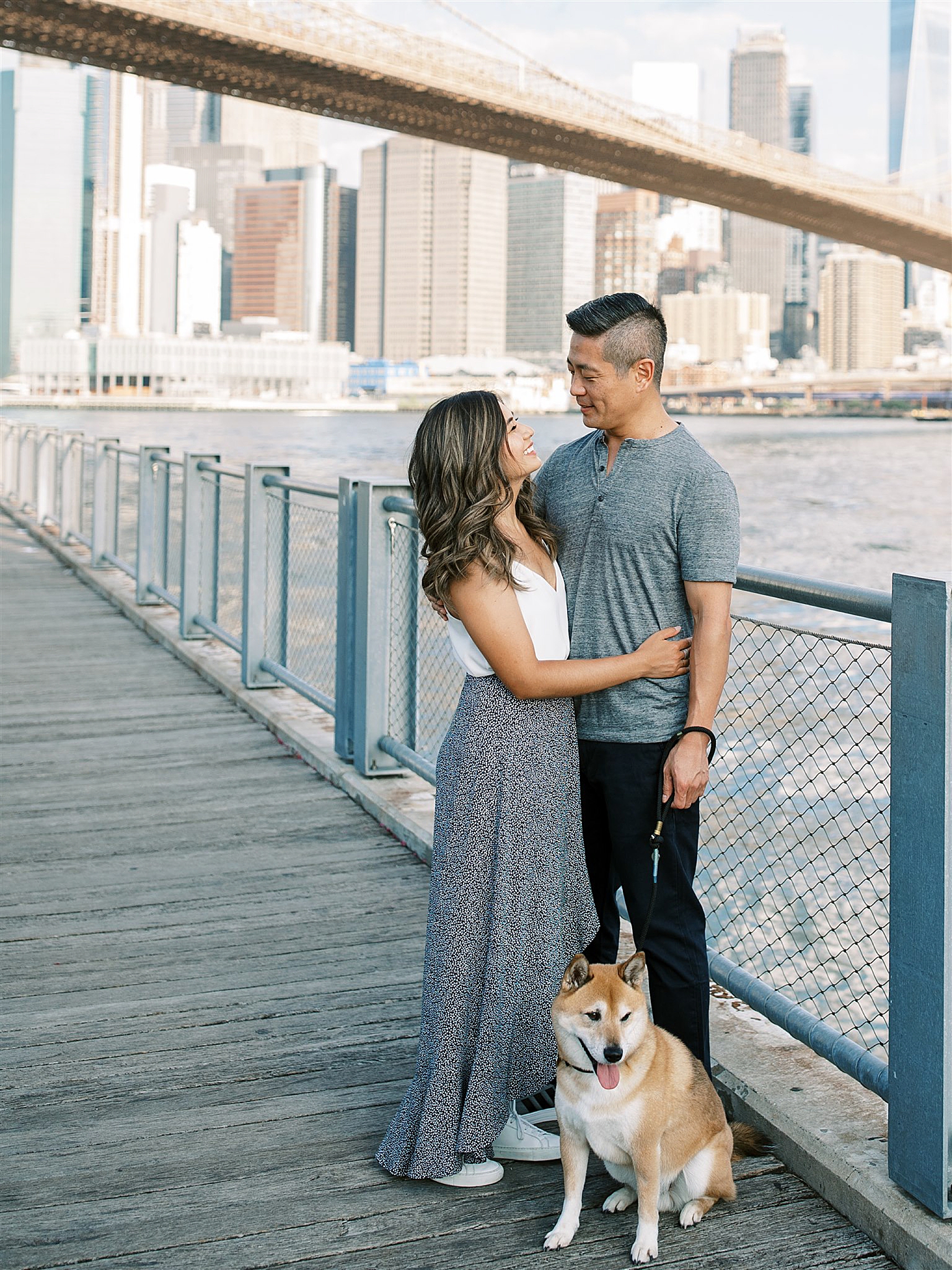engaged couple poses along Hudson River in NYC