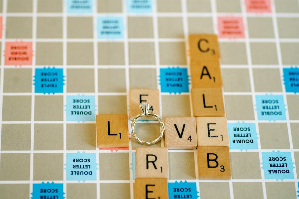 engagement ring rests on Scrabble board during Trinity House Cafe engagement photos 