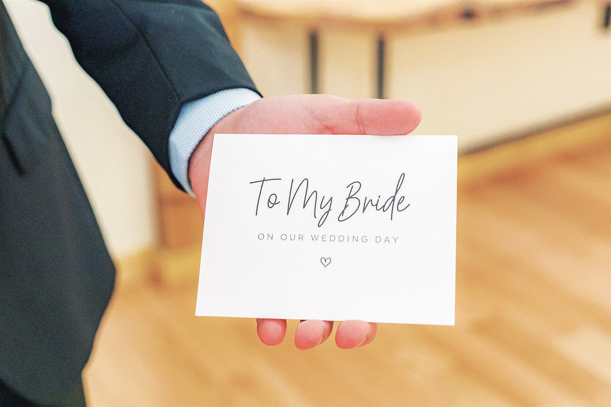groom holds letter to bride