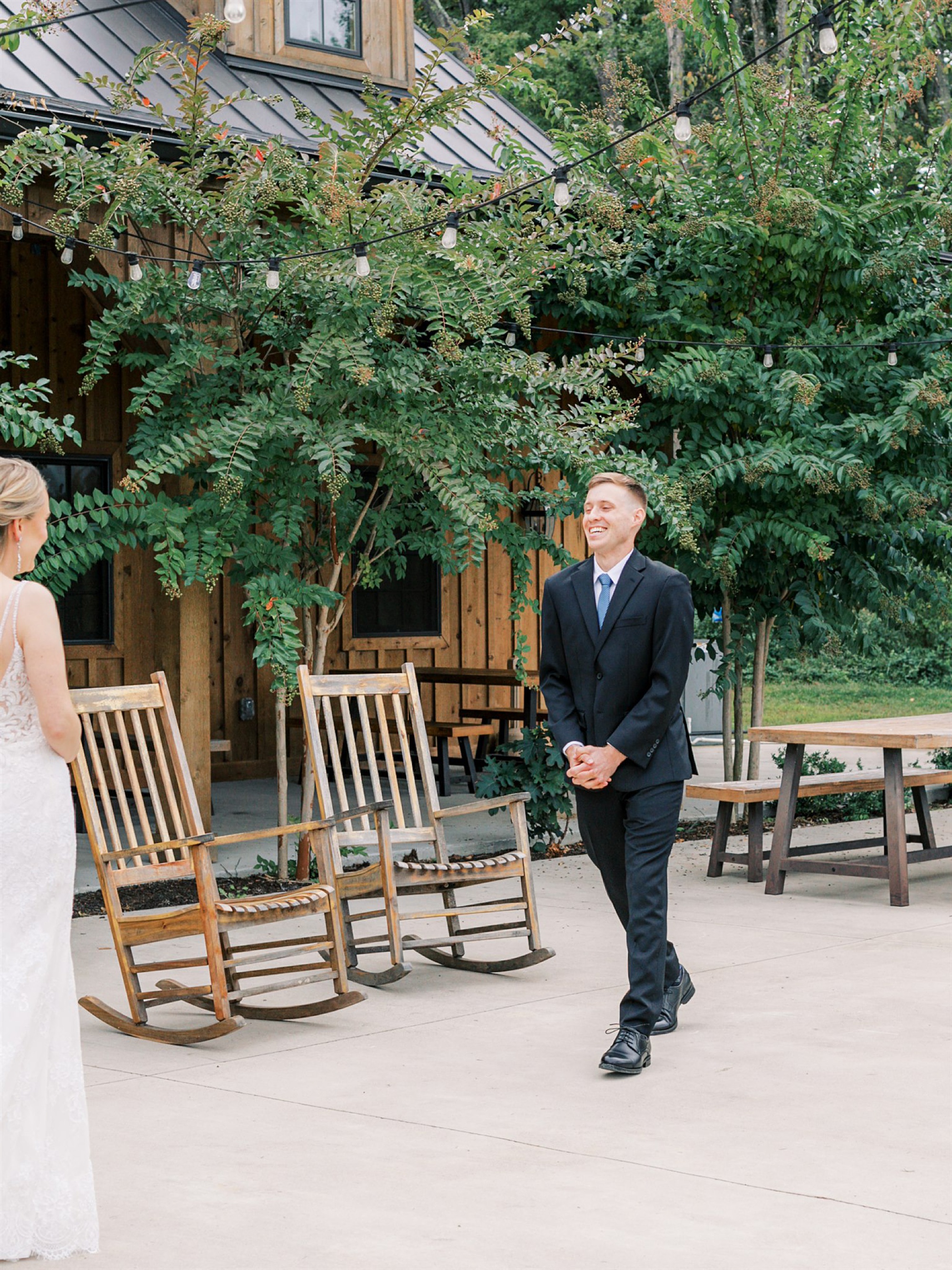 groom smiles at bride during first look at Mt Defiance Cidery