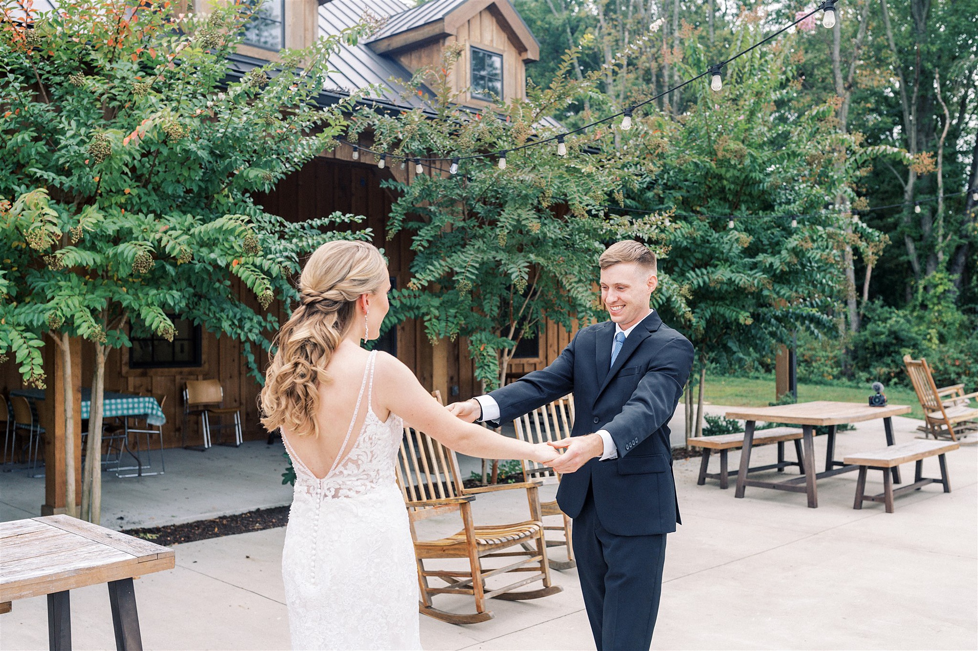 groom looks at bride during first look at Mt Defiance Cidery
