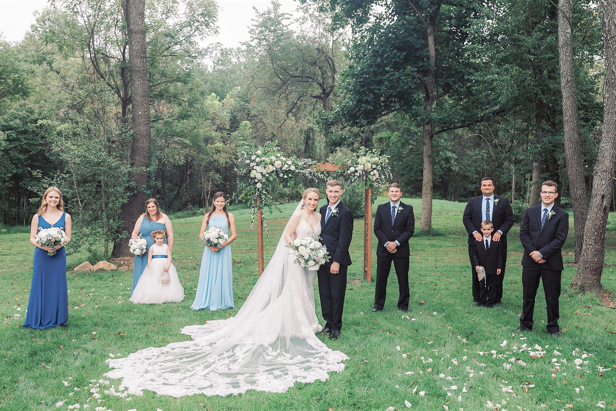 bride and groom pose with bridal party during fall wedding in Middleburg