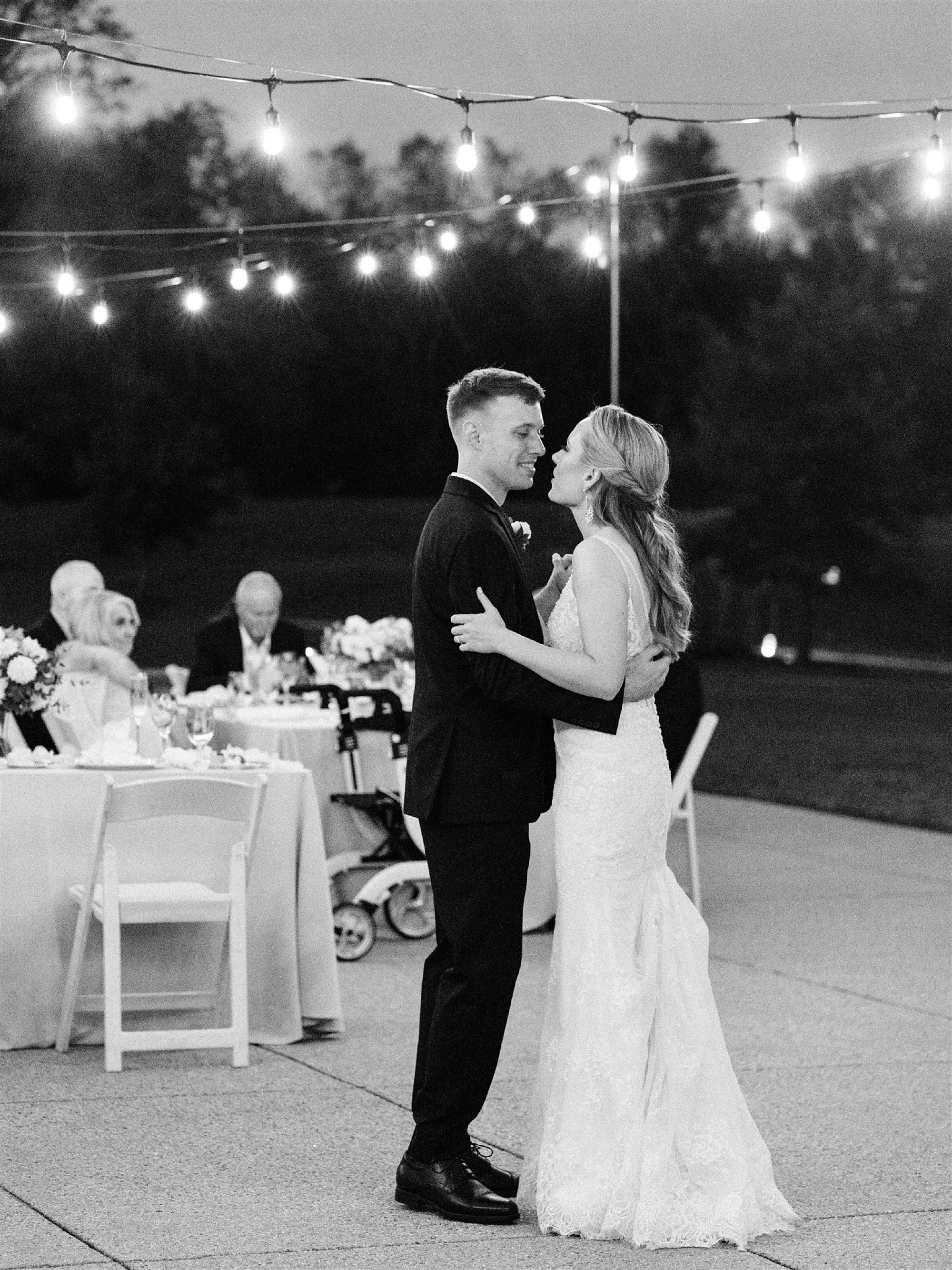 newlyweds dance under twinkle lights at fall wedding in Middleburg