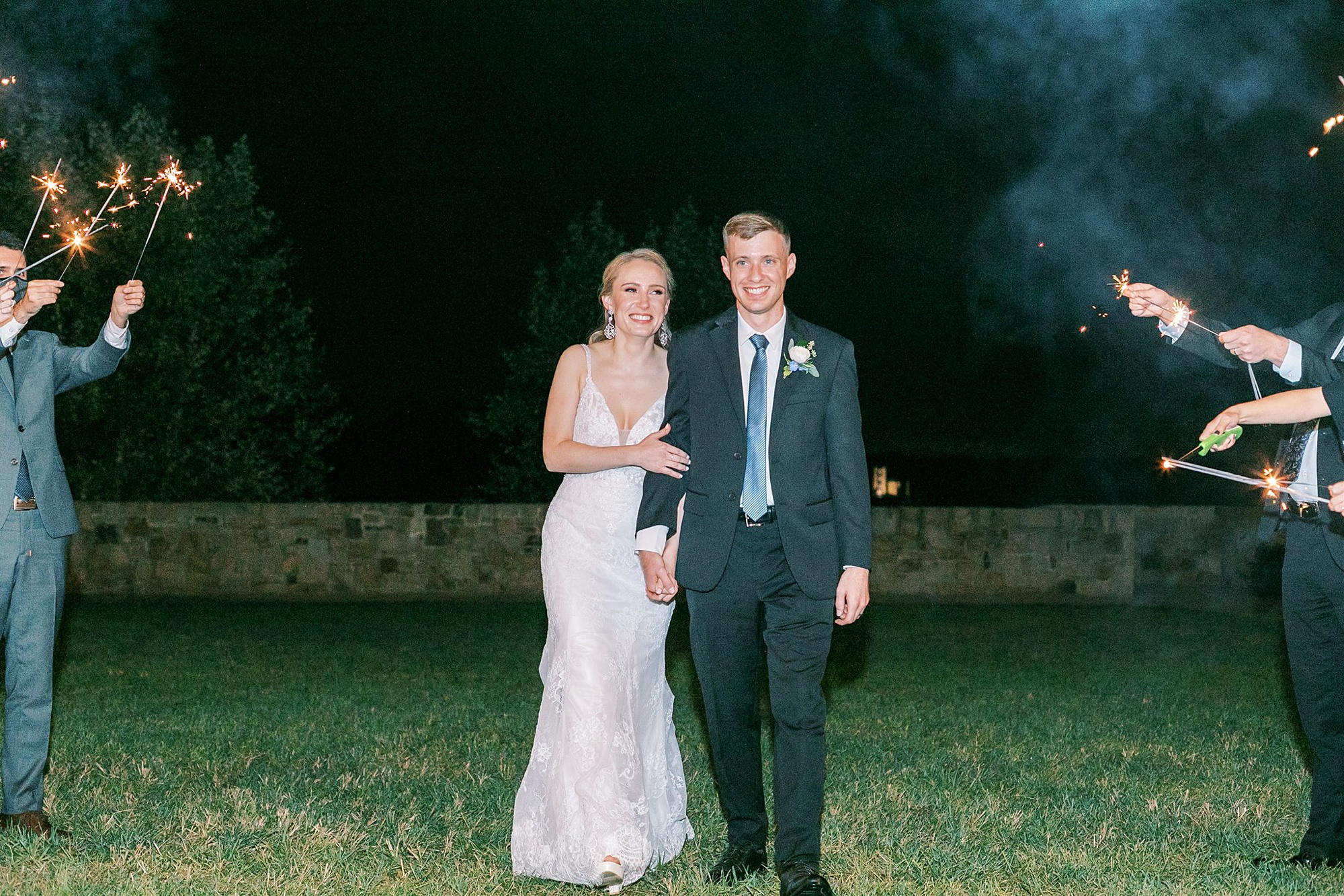 bride and groom walk towards sparkler exit during fall wedding in Middleburg