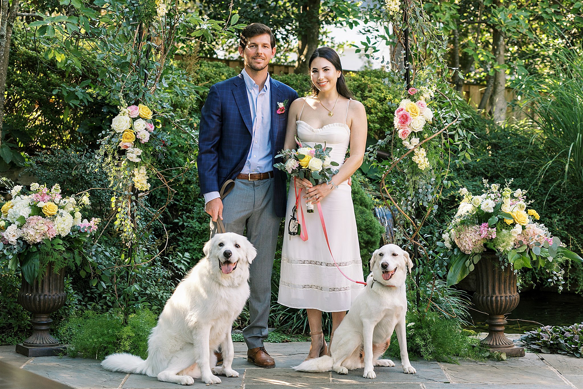 couple poses with dogs during Intimate Wedding at Home