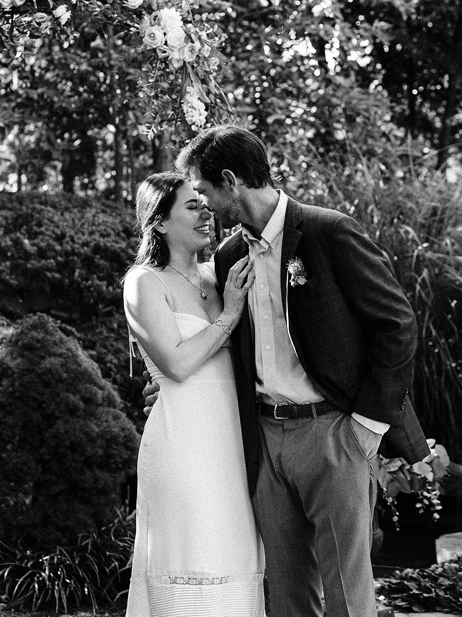 newlyweds kiss in garden at home during elopement