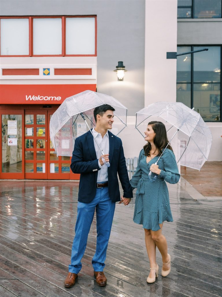 rainy engagement in Old Town Alexandria with couple under clear umbrellas