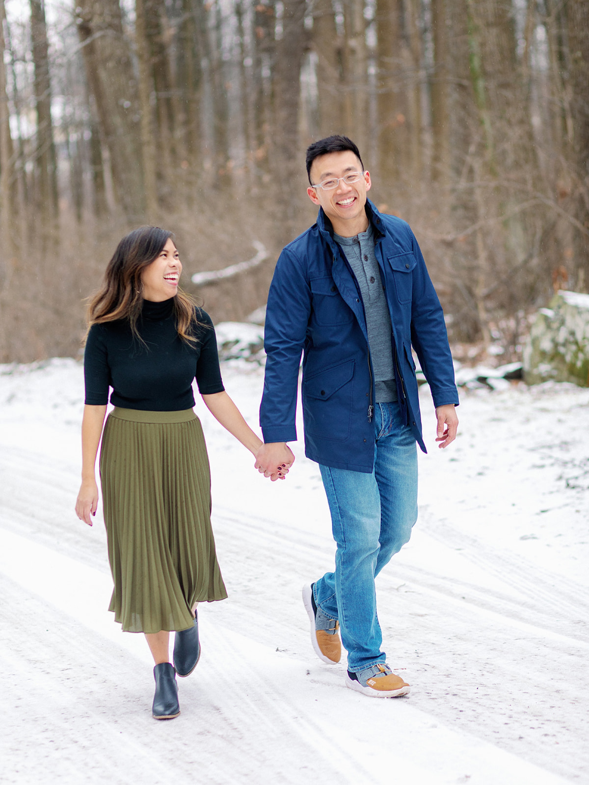 engaged couple holds hands during Snowy Engagement Session in Bluemont, VA 