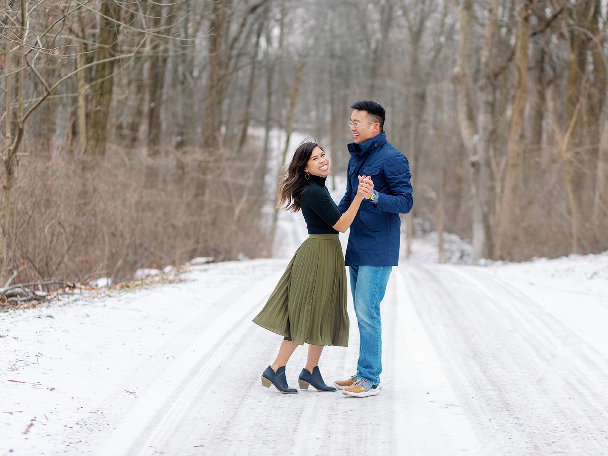 couple dances on pathway in the snow
