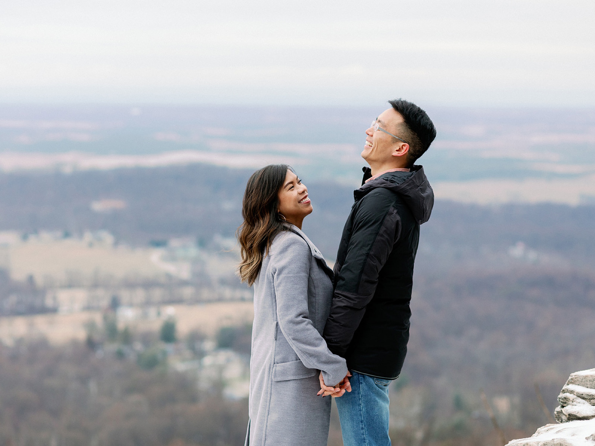 couple holds hands and laughs during VA engagement photos