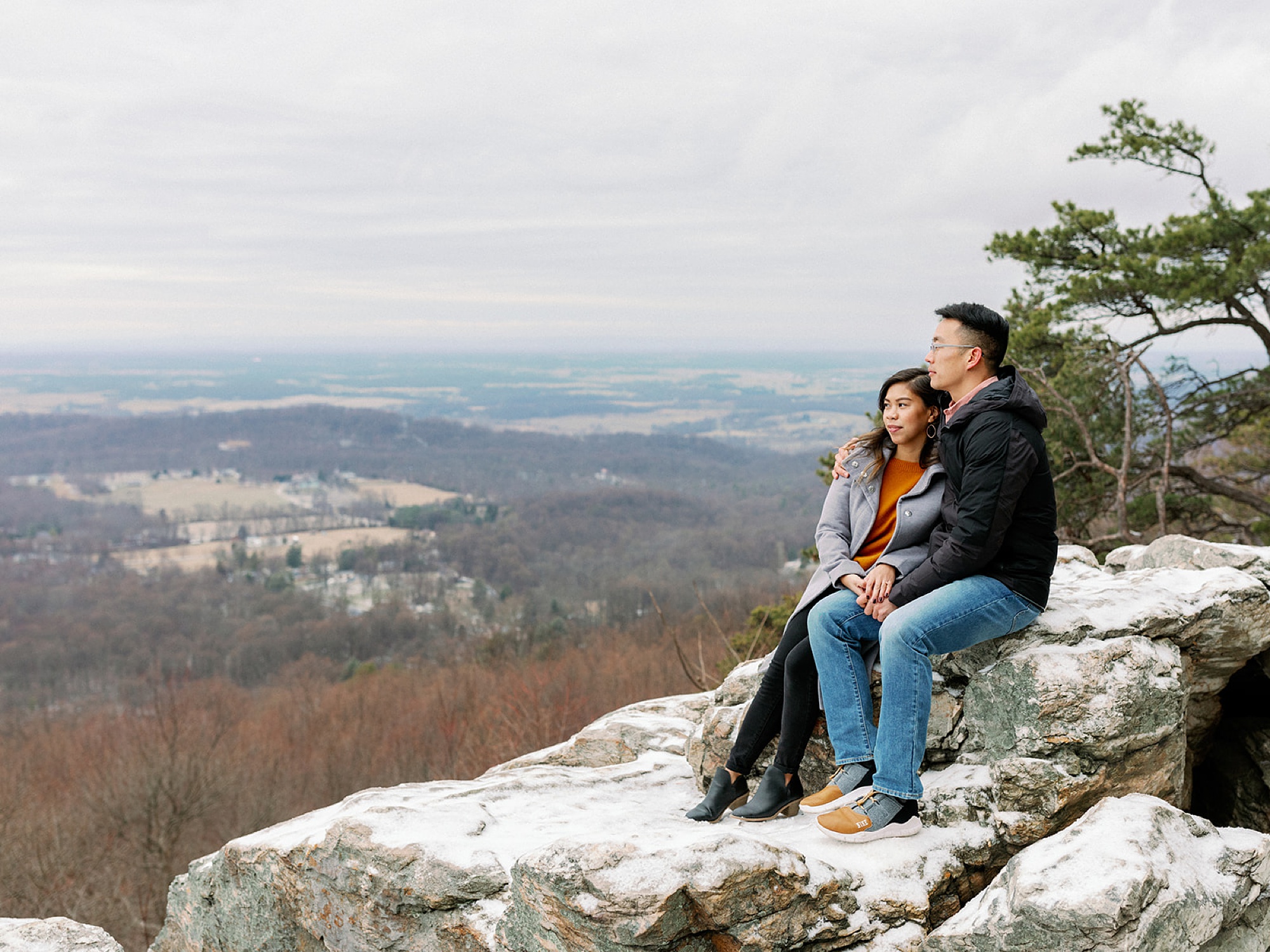 couple sits on rocks looking over Bluemont VA